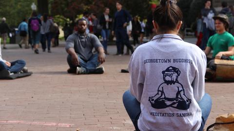 circle of students meditating