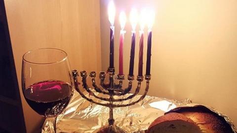 Hanukkah wine, candles, and challah