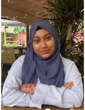 Headshot of woman in blue hijab