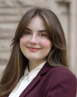 headshot of woman standing in front of wall
