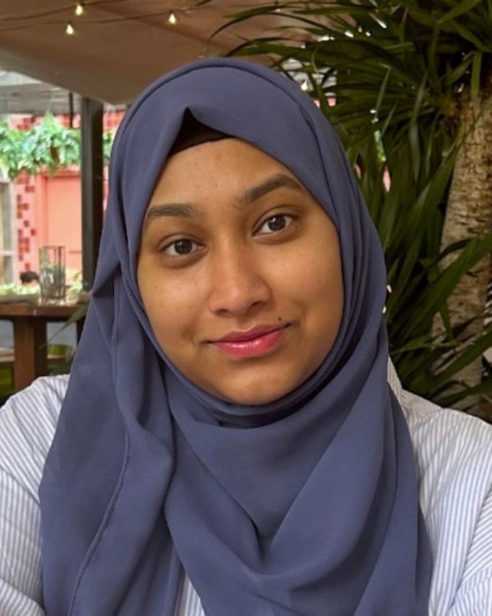 Headshot of woman in blue hijab